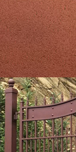 Close-up of a Canyon Rock color textured surface above a matching metal gate with decorative finials and a curved design.