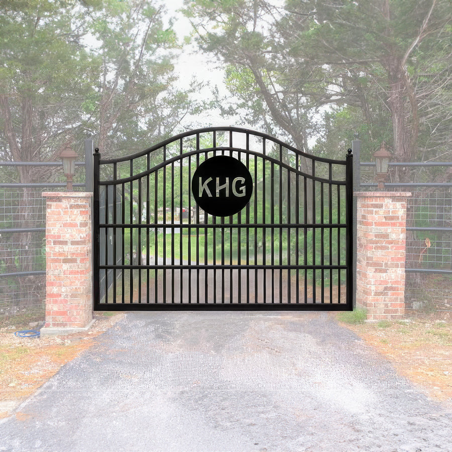 KHG letters in black metal circle on black metal single gate on driveway