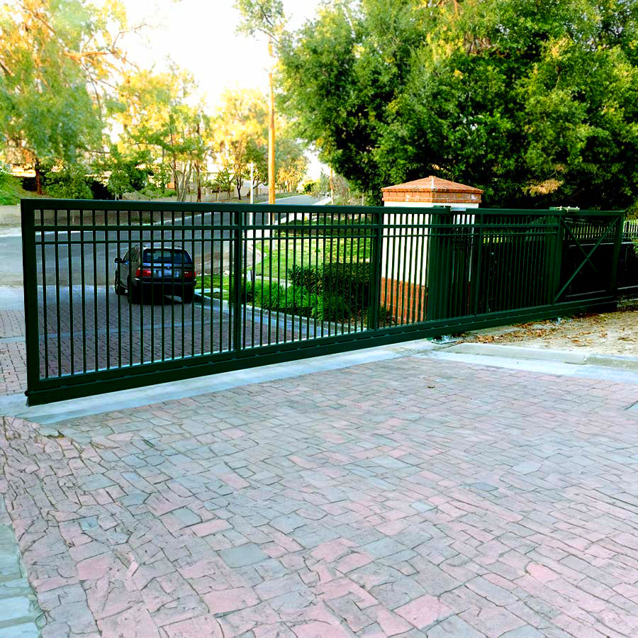 simple vertical bar metal slide gate on cobblestone driveway opening