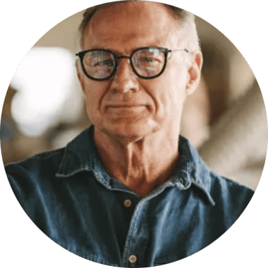  smiling older man with denim shirt and glasses as face of amazing gates tech support 